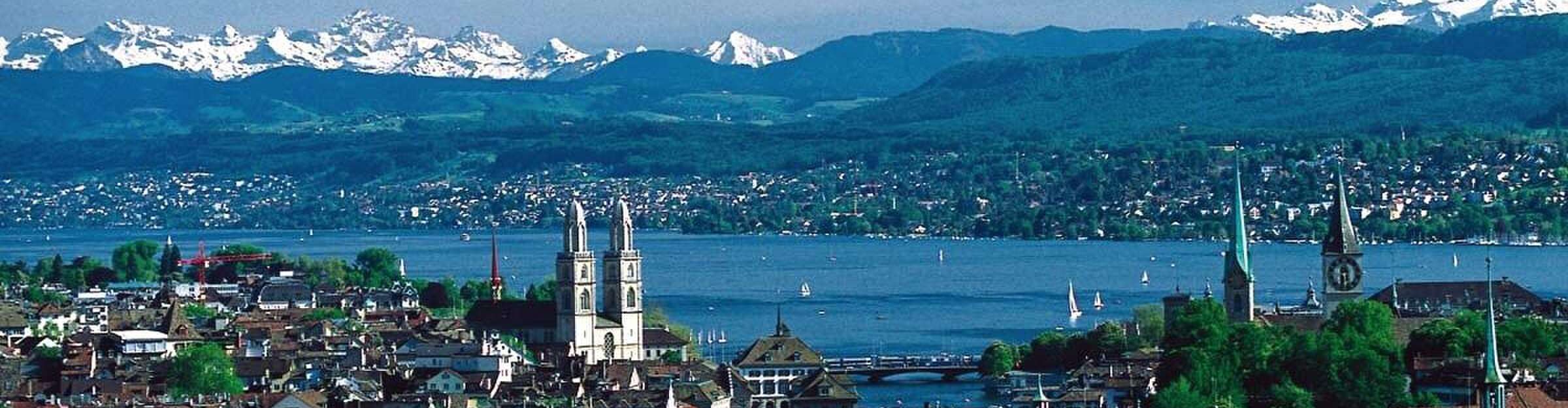 Zurich's Altstadt and the Grossmünster towers with the lake and the Alps behind